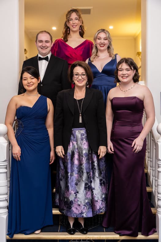 Aylish Ryan, front right in a plum gown, with her fellow finalists of the IFAC HANDA Australian Singing Competition